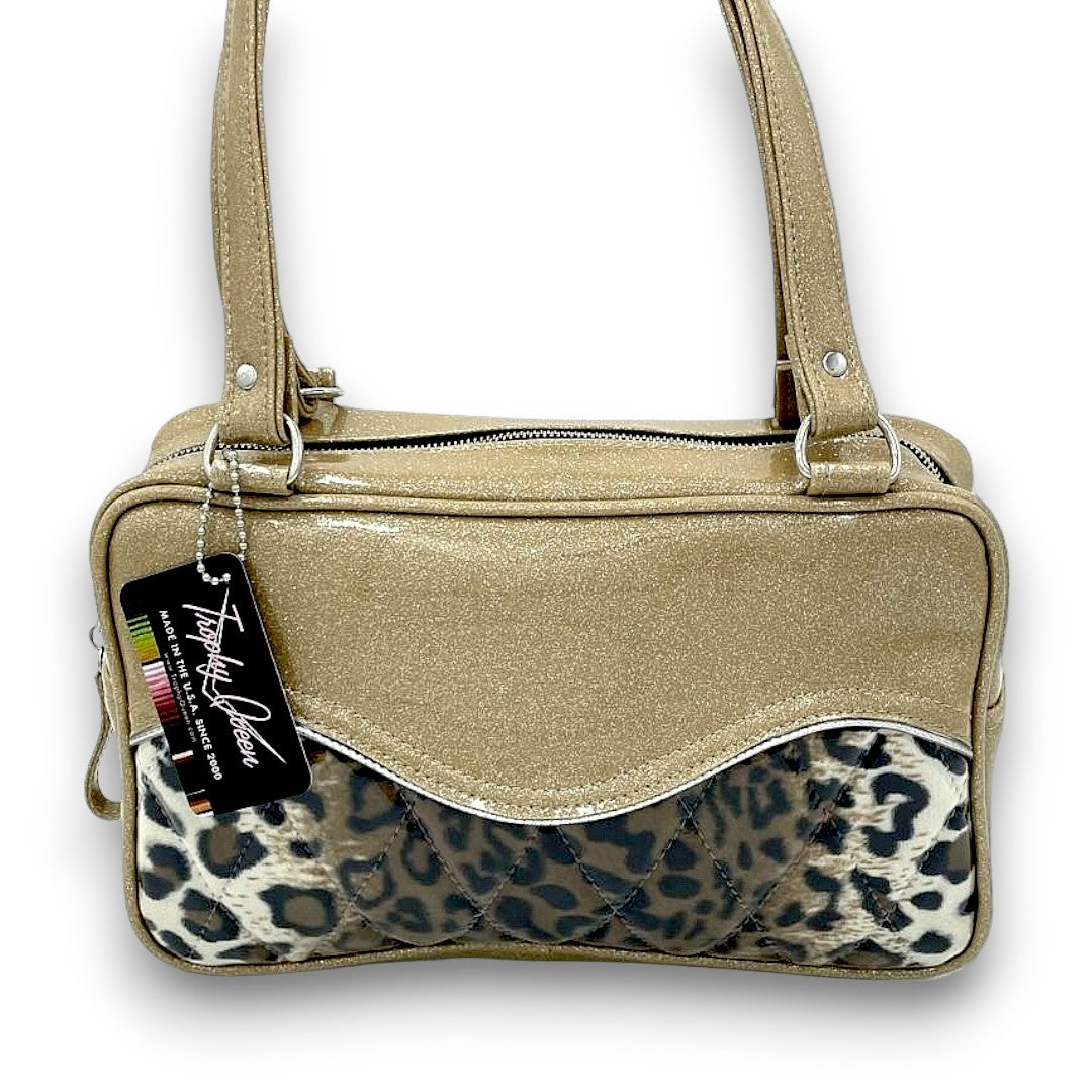 Diamond Pleat Tuck & Roll Tote American Made Plush Leopard Lining Dimensions: 13" x 8" x 4" 25" Straps (Approx.) with Nickel Hardware Comes with an Extra Set of Replacement Straps! Inside Zipper Pocket (With Serial Number Inside) Inside Open Divided Pocket Inside Trophy Queen Label Vinyl Zipper Pull Nickel Feet Made to Order - Please Allow 2-3 Weeks to Ship