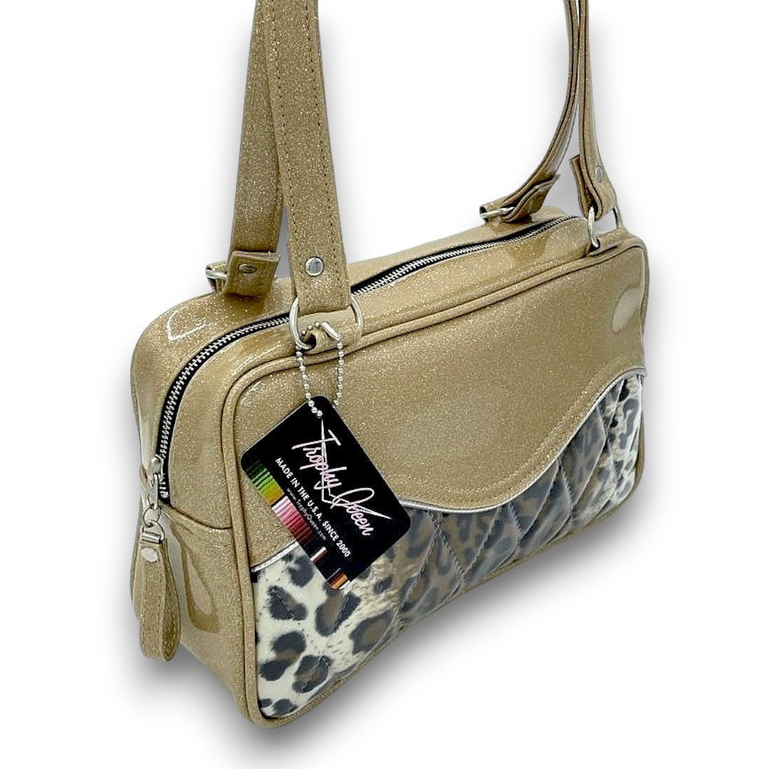 Diamond Pleat Tuck & Roll Tote American Made Plush Leopard Lining Dimensions: 13" x 8" x 4" 25" Straps (Approx.) with Nickel Hardware Comes with an Extra Set of Replacement Straps! Inside Zipper Pocket (With Serial Number Inside) Inside Open Divided Pocket Inside Trophy Queen Label Vinyl Zipper Pull Nickel Feet Made to Order - Please Allow 2-3 Weeks to Ship